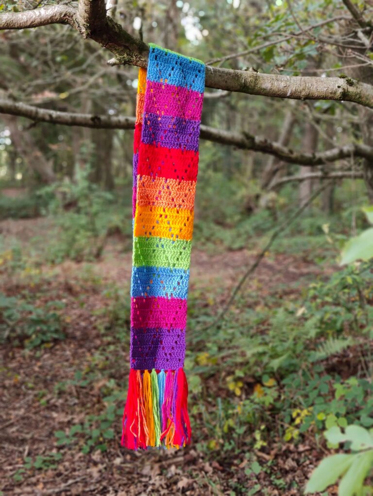Rainbow crocheted scarf on tree