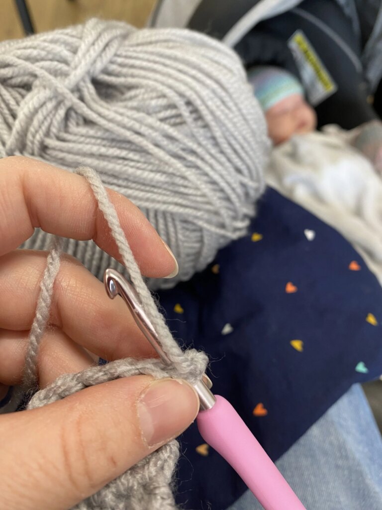 Crocheting grey yarn baby
