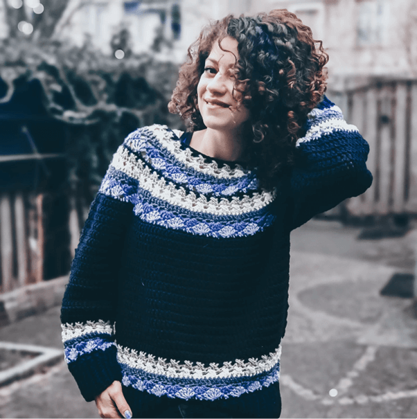Curly-haired woman crochet sweater