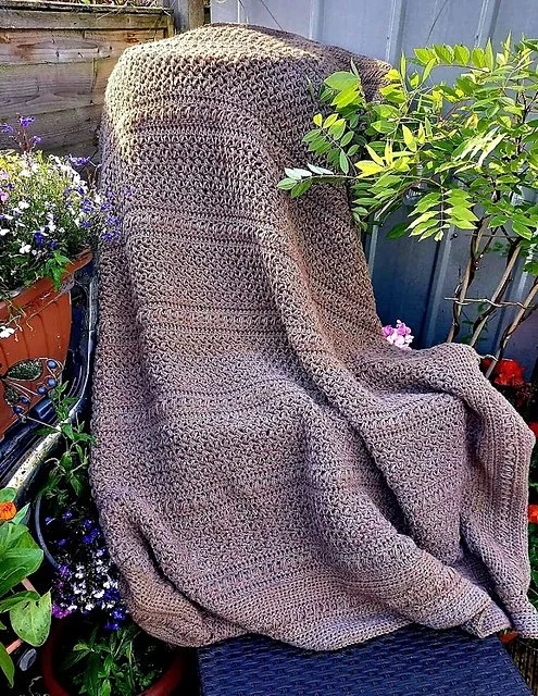 Brown crocheted blanket garden