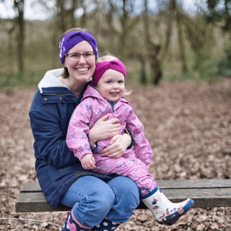 Smiling mother daughter forest