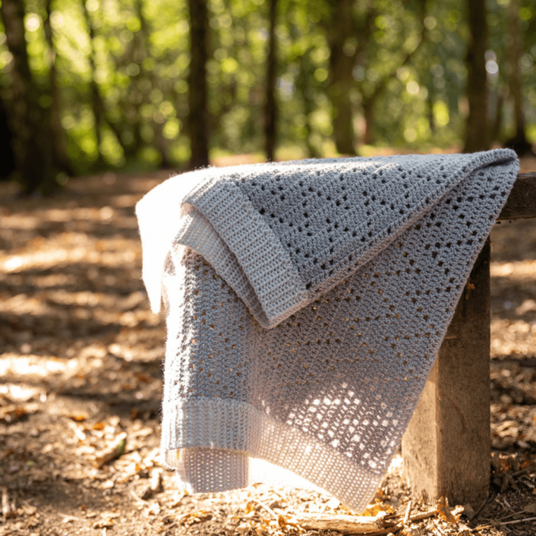 Grey crochet blanket forest sunlight