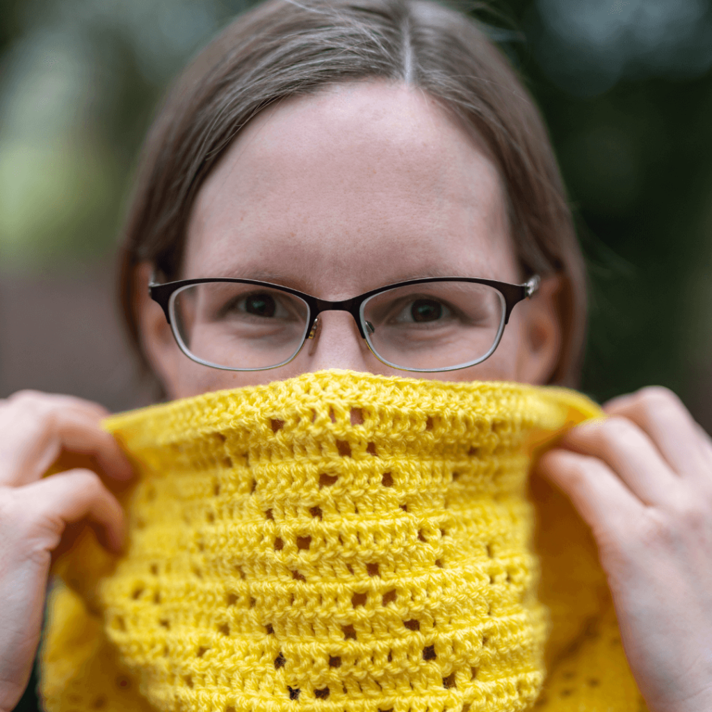 Woman with yellow crochet cowl