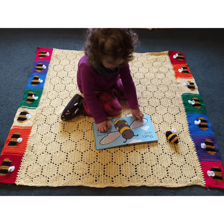 Child on bee crochet blanket