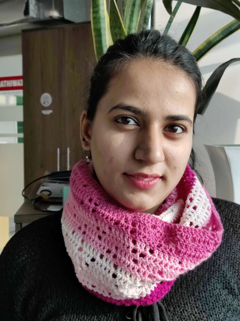 Smiling woman pink crochet scarf