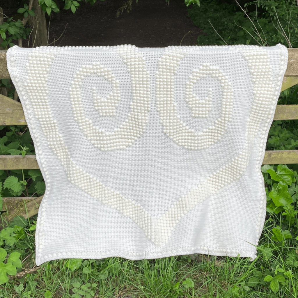 White crochet heart blanket