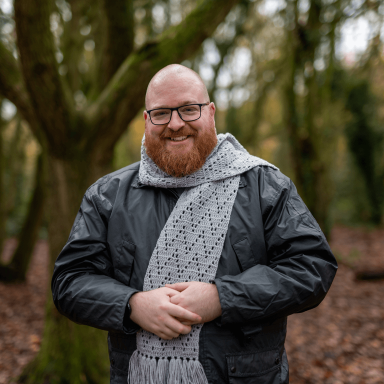 Smiling man crochet scarf
