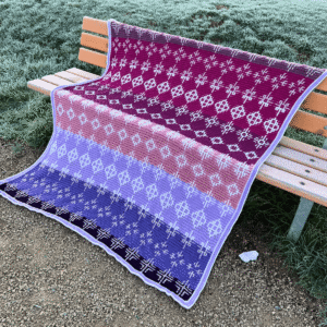 Geometric crochet blanket on bench