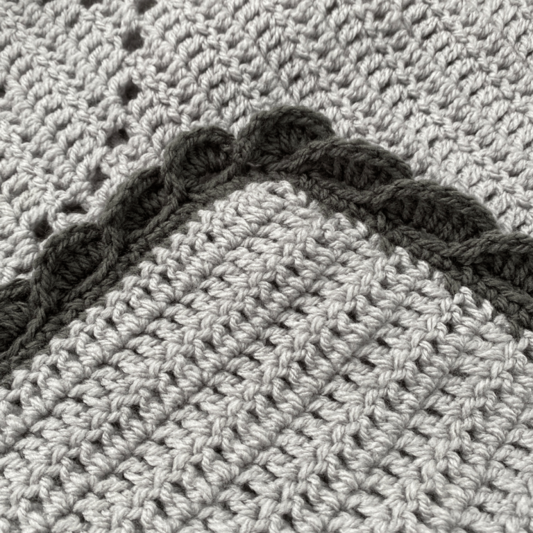 Grey crocheted blanket corner
