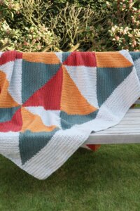 Geometric crochet blanket on bench