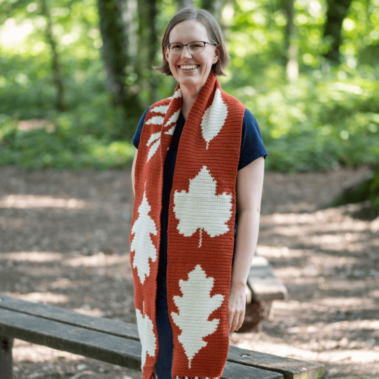 Smiling woman crochet leaf scarf