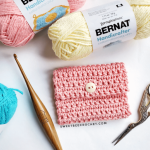 Pink crochet pouch, yarn, hook