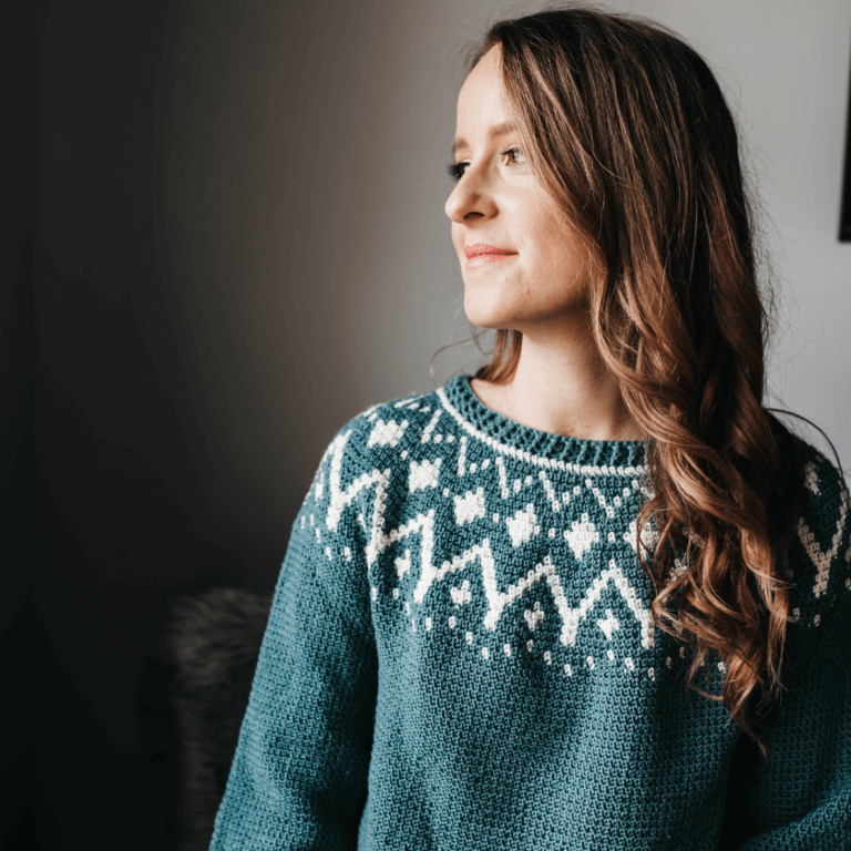 Woman in teal crochet sweater