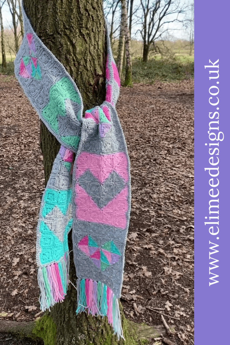 Colorful crochet scarf on tree