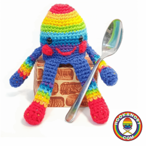 Rainbow crochet octopus holding spoon