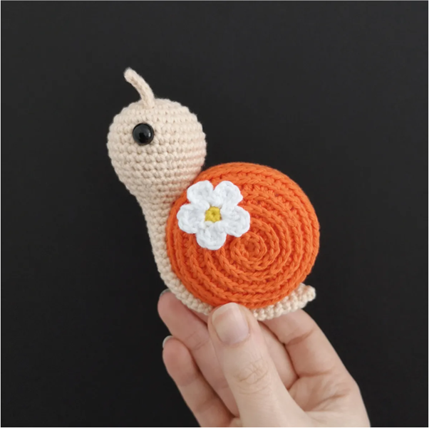 Orange shell crochet snail flower