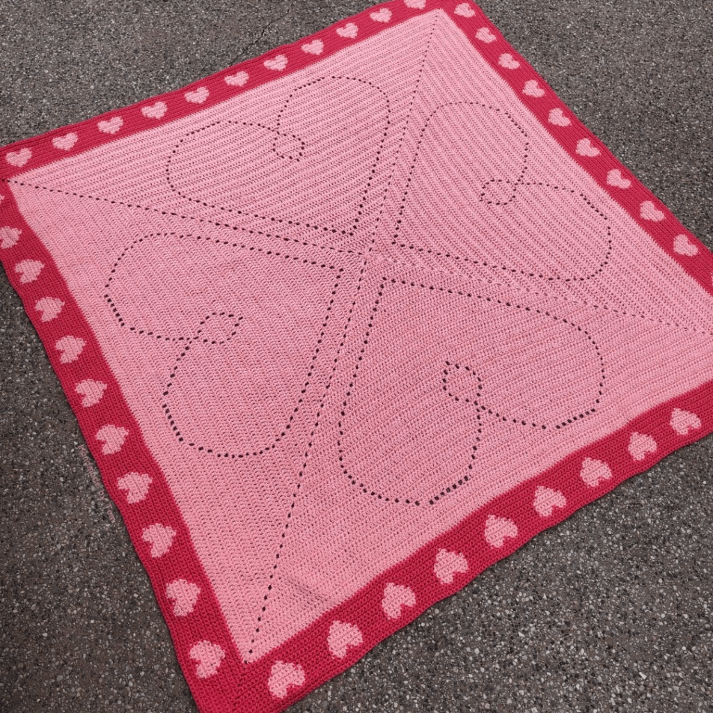 Pink crocheted heart blanket